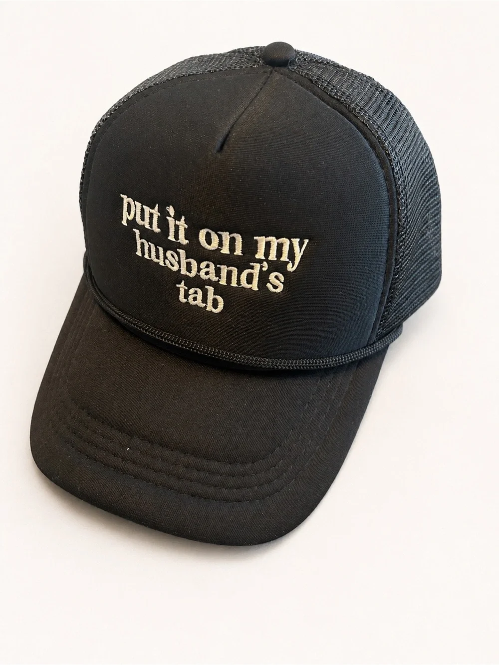 Black Trucker Cap with 'put it on my husband's tab' Embroidery